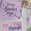 Photo d'un classeur de budget ouvert avec des feuilles organisées, montrant une gestion financière claire.